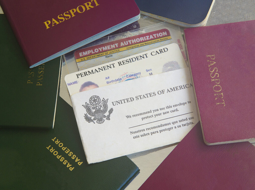Picture of passports, permanent resident card, and employment authorization