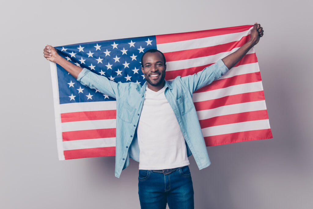 a man from a major sports league holding up an american flag